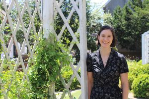 Susannah stands in the Read House gardens smiling at the camera.